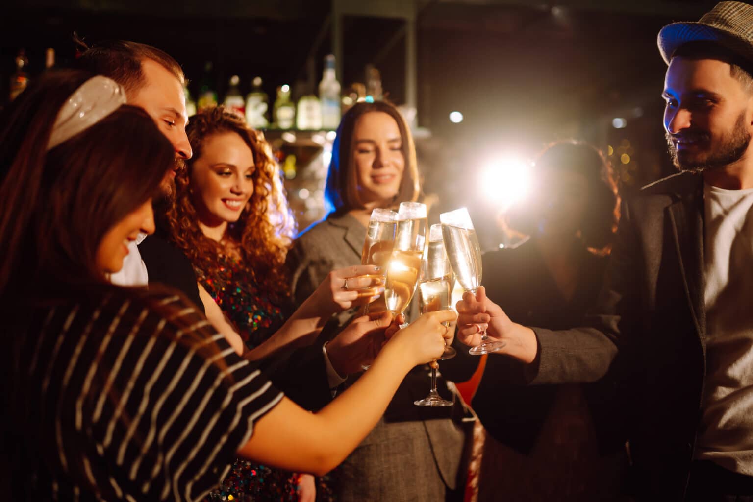 Group of friends cheering with cocktails on a night out