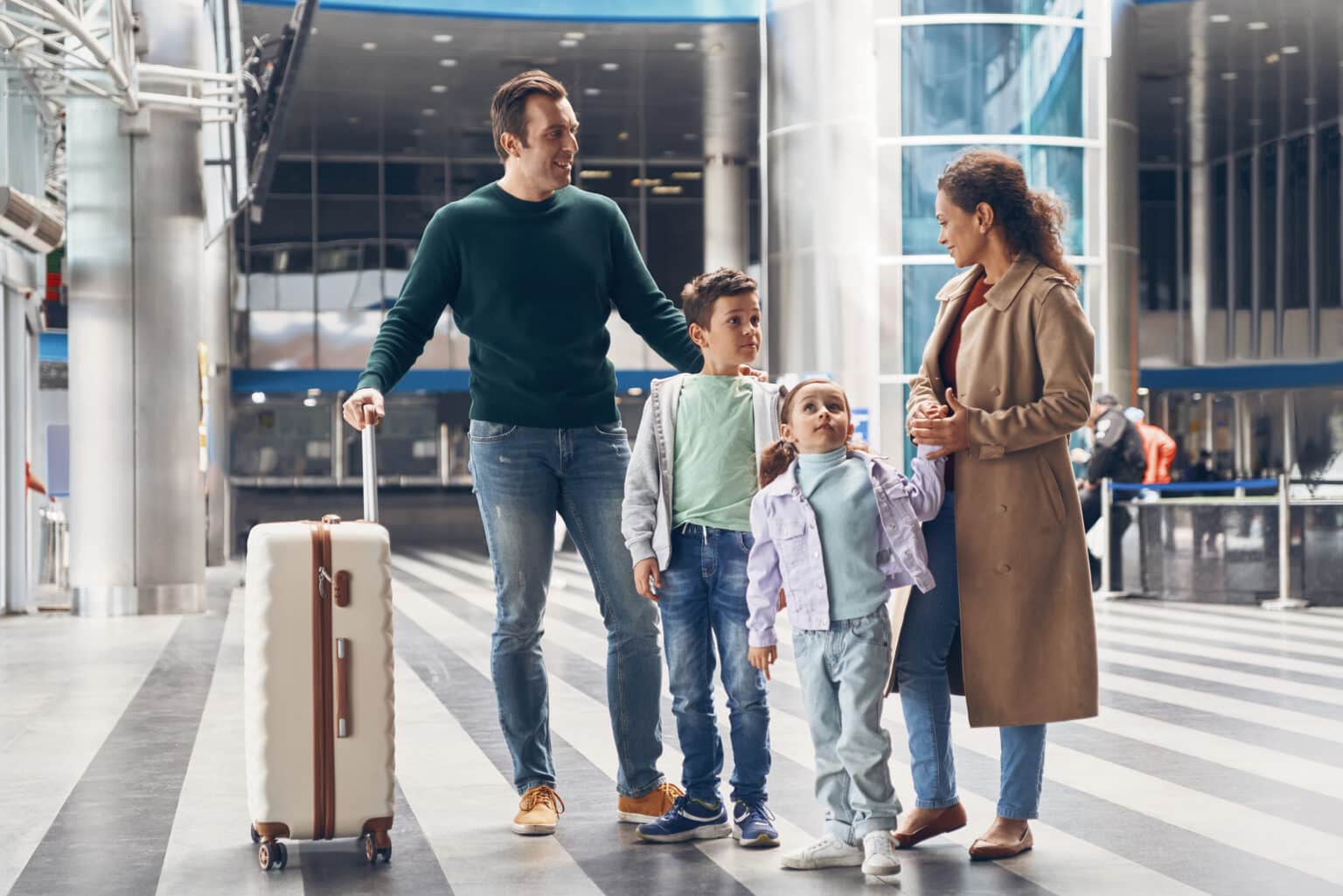 Family with their suitcase waiting at the airport