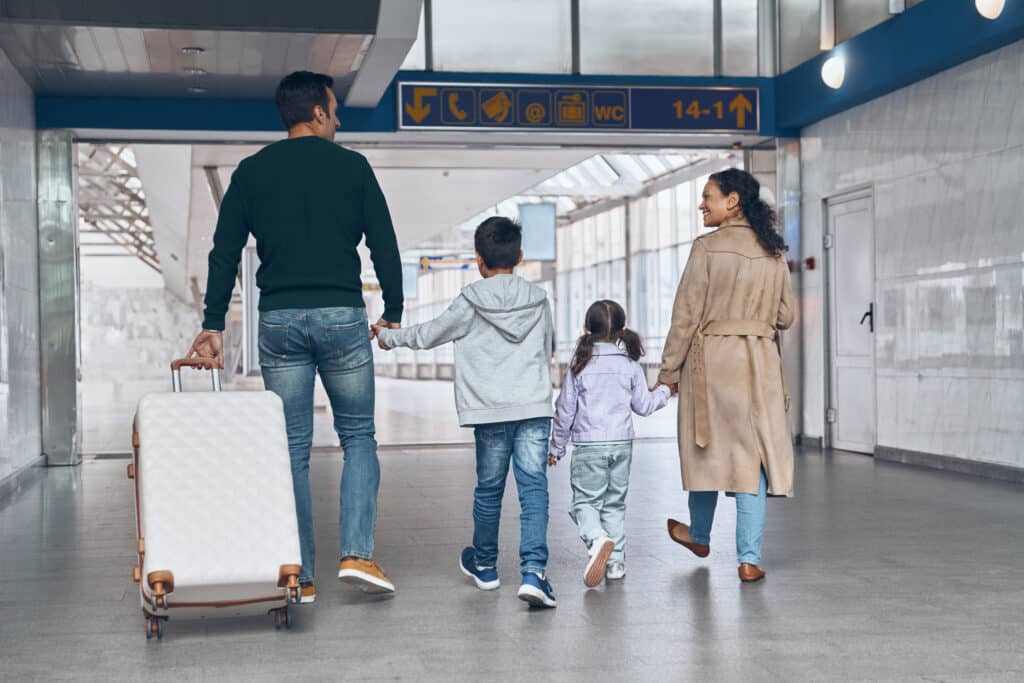 Family walking through an airport terminal together