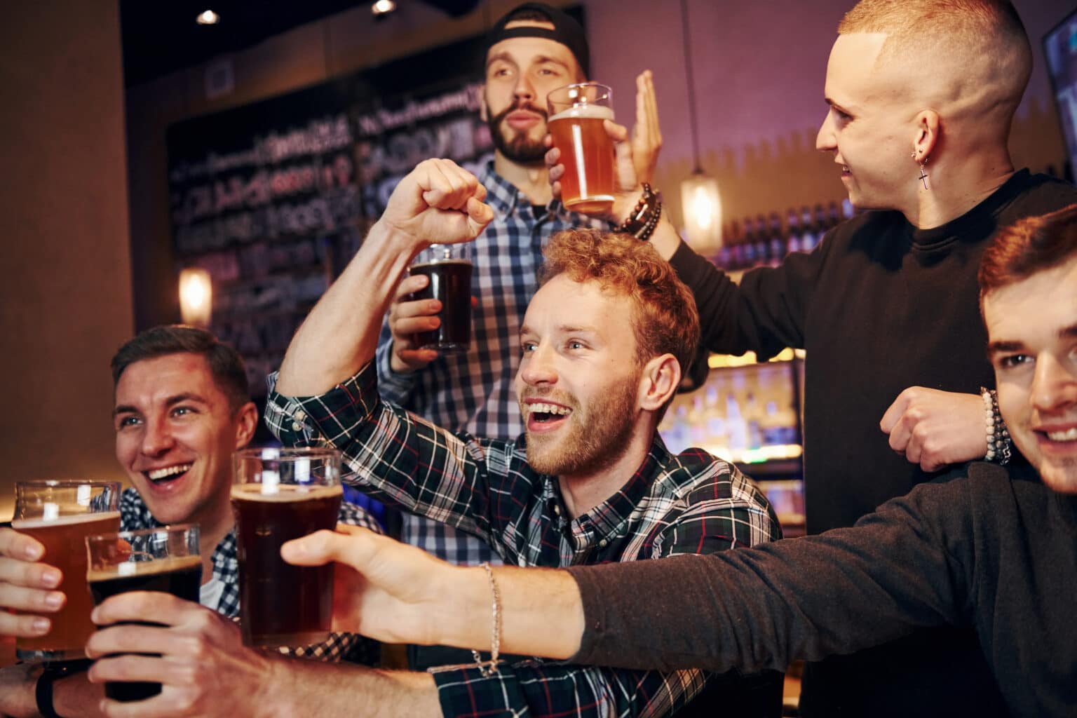 Group of friends celebrating in a pub