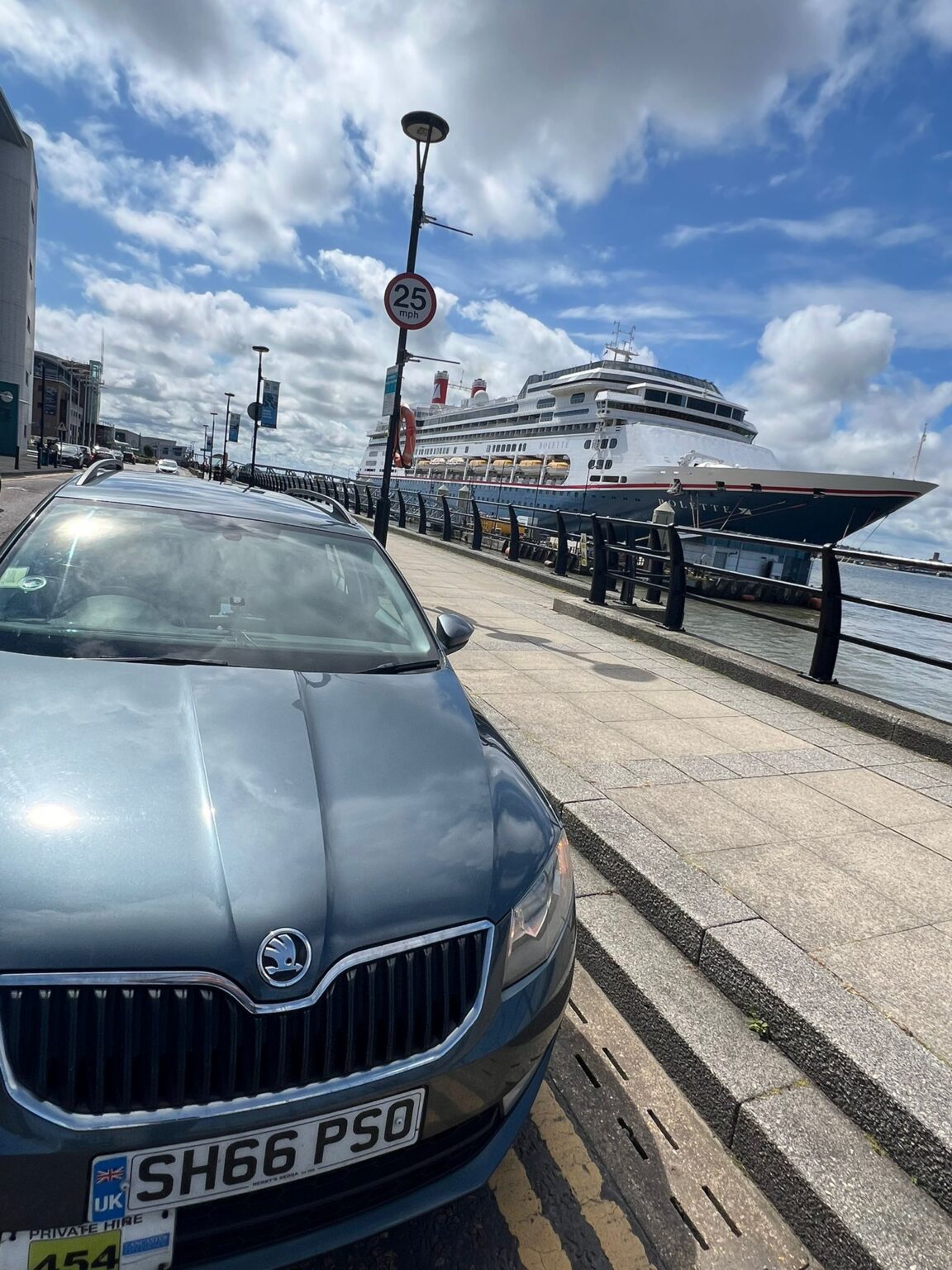 MW Transfers car beside a cruise ship at Liverpool cruise terminal
